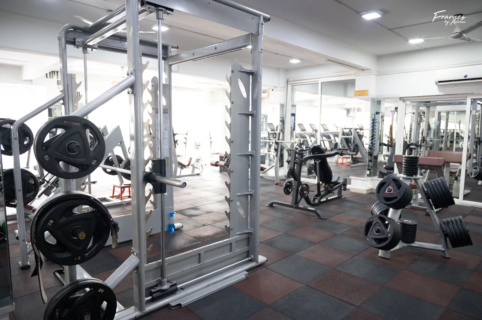 Spacious resistance-training floor with strength machines and benches.