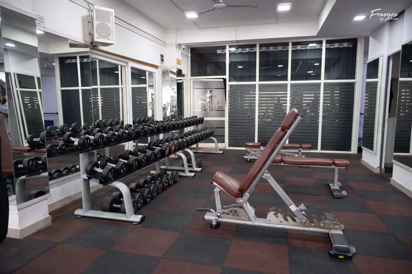 Trainer-led strength area with benches and upper-body equipment at Power Fitness Club.